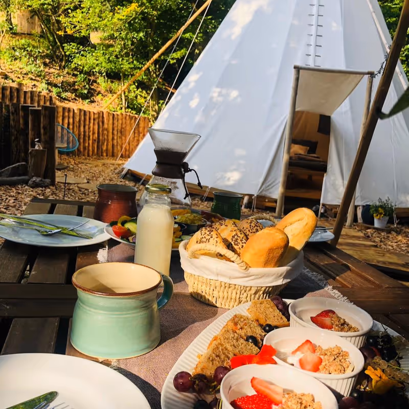Snídaně na stole před teepee - Ubytování Křivoklátsko - Glamping Nad Meandry